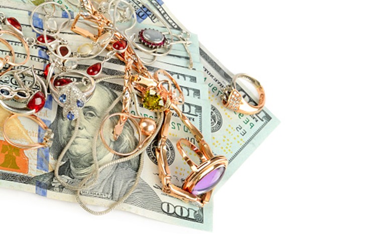 A pile of money and jewelry